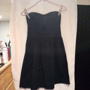 Woman's small black strapless dress